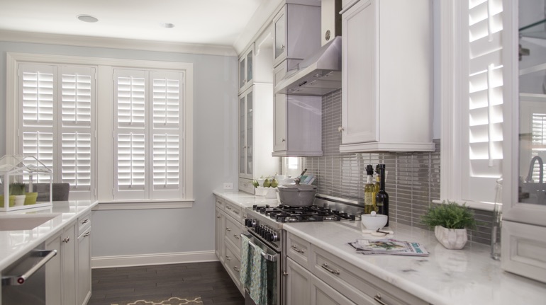 Plantation shutters in Gainesville kitchen with white cabinets.